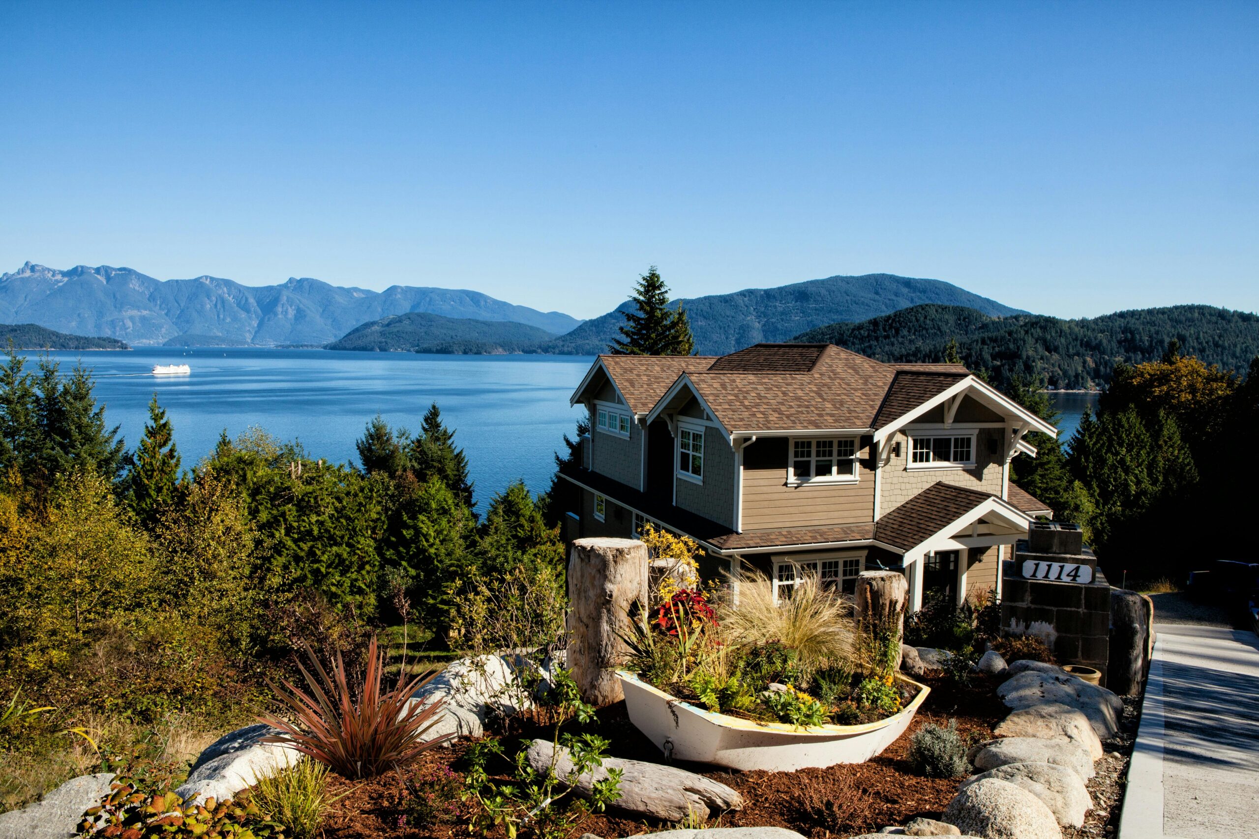 A detached home in a BC neighbourhood surrounded by mature trees and natural light, representing private mortgage lending options in British Columbia.